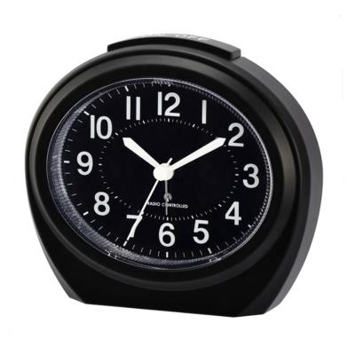 China Creative Radio Press Coverage For Oval Backlight Alarm Clock Radio Controlled Table Analog Alarm Clock for sale