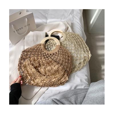 China Fashion ladies ring shopping bag hand-held cavity woven straw purse 2021 summer retro rattan handmade handbag for sale