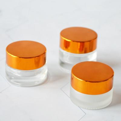 China Cosmetic Hot Sale 5ml 7ml Clear Round Eye Glass Cream Jar With Gold Lid for sale