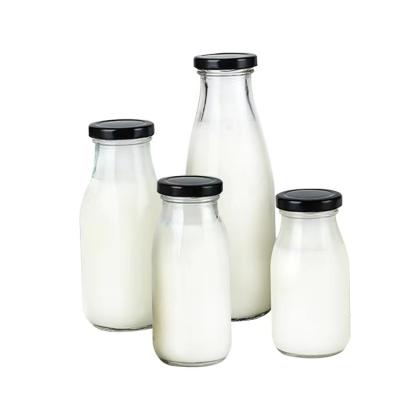 China High quality food factory empty round 250ml 300ml 500ml glass bottle with metal lid for milk for sale