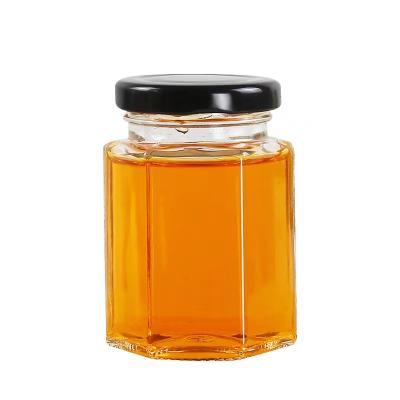 China Wholesale food honey jar 45ml 85ml 100ml 180ml 280ml 380ml 500ml 730ml hexagonal glass jam jar for honey with metal lid for sale