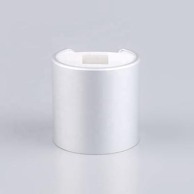 China Non Spill Aluminum Cosmetic Press Caps Disc Top Cap 24 410 Screw Top High End Plastic Lids for sale