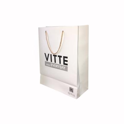 China Custom Recyclable Logo Baby Cloth White Art Recyclable Paper Bag With Handle for sale