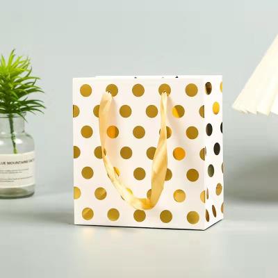 China Recyclable Gear Paper Shopping Bag Making Machine Craft Kraft Paper Block Bottom Gift Bag With Gold Dots for sale