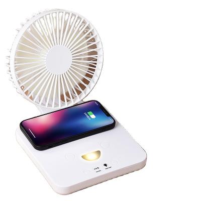 China Combine with new arrival wireless foldable handheld tabletop fan small rechargeable wireless charger function novelty desktop fan battery wireless Table Shenzhen for sale