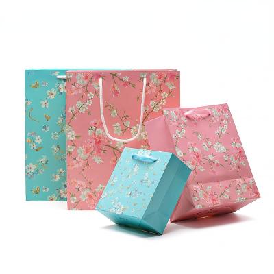 China Recyclable Floral Jewelry Gift Cardboard Packaging Double Sided Printed Paper Bag for sale