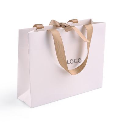 China Recyclable Custom Luxury Cardboard Ribbon Handle White Shopping Tote Bag Customized Printed Paper Gift Bags With Your Own Logo for sale