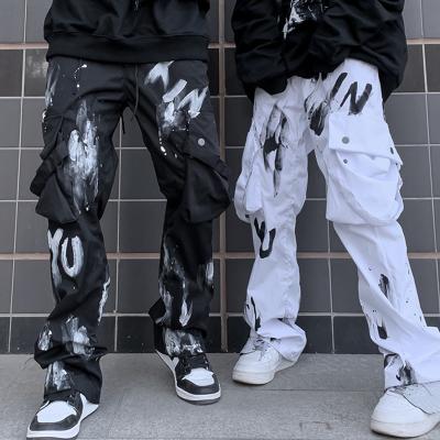 China 2022 QUICK DRY new popular hip hop dance graffiti printing multi pocket cargo pants men's black and white casual loose straight leg pants for sale