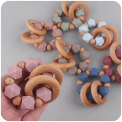 China Baby Teething Toys Rattle Soft Bpa Free Cartoon Wood Baby Teether Ring Kids Food Grade Baby Silicone Teether for sale