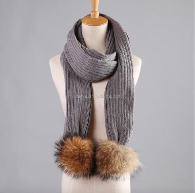 China Long Winter Knit Scarf With Detachable Real Raccoon Fur Pom Poms UK Style Knitted Scarves for sale