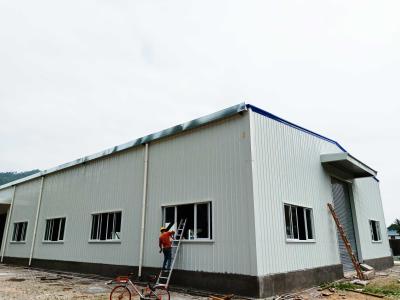 China Fireproof Material Metal Steel Plate Steel Structure Building Warehouse With Electric Rolling Shutter Door for sale