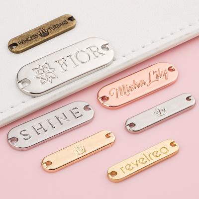 China Custom Metal Name Tags For Swimwear Metal Bag Bikini Logo Tag Sew Clothing Labels for sale