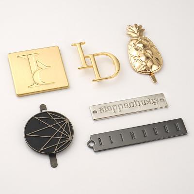 China Sewing Clothing Tags Custom Gold Pineapple Engraved Metal Name Plates For End Garments for sale