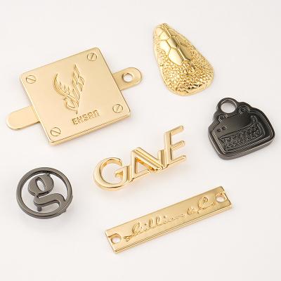 China Washable Custom Gold Sewing Metal Clothing Labels Design Hanging Tag Bag Metal Logo Letters Nameplate for sale