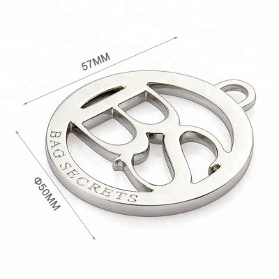 China Custom Hollow Logo Metal Hang Tags for Handbags Silver Metal Circle Tag Handbag Hardware for sale