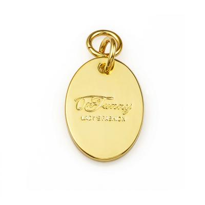 China Customized Gold Metal Hang Tag for Handbags ROHS Certified Engraved Oval Shape Name Tag for sale