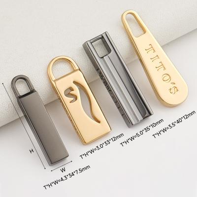 China Engraved Logo Gold Zipper Puller Customized for Handbags and Bags in Metal Material for sale