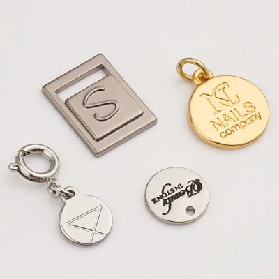 China Small Metal Logo Bag Tag with Plated Technique and 1 Color Print Method Metal Tag for sale