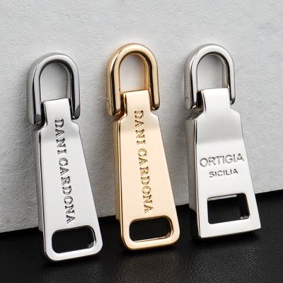 China Non Lock Slider Type Gold Bag Zip Pulls with Custom Engraved Logo and Silver Puller for sale