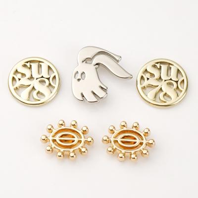 China Customized Size Metal Clothing Logos with Small Gold Logo Metal Tag Cut Out Logo for sale