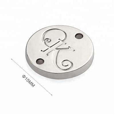 China Custom Nickel Sewing Metal Logo Tag for Clothing 15mm Round Shape With 2 Holes Design for sale