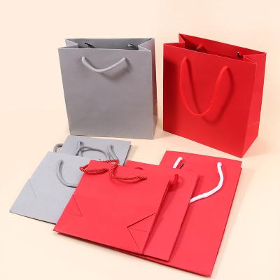 China Recyclable Factory Supply Customized Logo Luxury Paper Gift Bag Clothes Packaging Reusable Paper Shopping Bag With Handle for sale