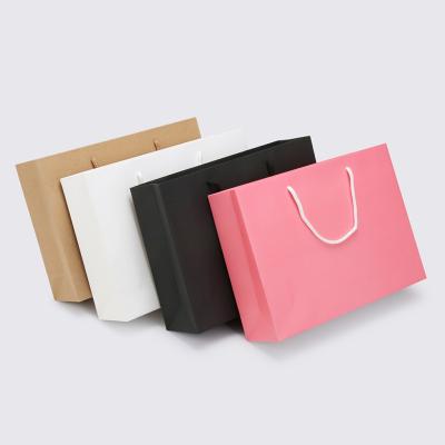 China Luxury Wholesale Recyclable Matte Black Gift Shopping Paper Bag With Logo Bag For Clothing Custom Packaging for sale