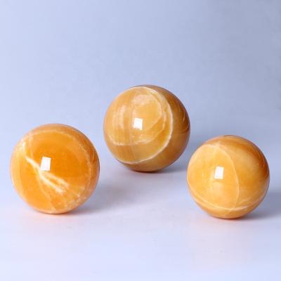 China Wholesale Calcite Yellow Orange Crystal Sphere Decorative Europe Calcite Sphere Ball for sale