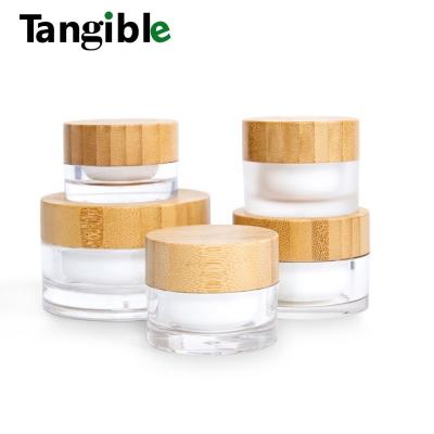 China 5ml cosmetic 10ml 15ml 30ml 50ml 100ml frosted glass bottles wholesale creams cosmetic jars with bamboo lid for cosmetic packaging for sale