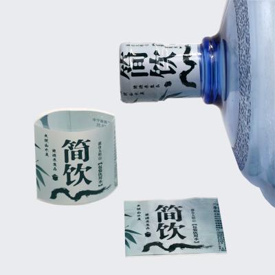 China Heat Sensitive Custom Packaging Label Heat Shrink Wrap Seal Printed Plastic For 5 Gallon Water Bottle Cap for sale