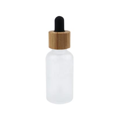 China High Quality Competitive Price Customized Colorful Matte White Glass Bottles 30ml Bamboo Rubber Essential Oil Bottles Base Cap+Glass Pipette+Silicone Frosted Bottle With Dropper for sale