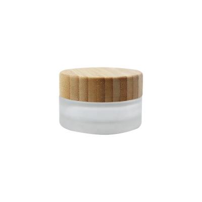 China Eco-friendly bamboo cap with eye pad 30g empty matte face body wooden cosmetic packaging container frosted 30ml glass cream jar with bamboo lid spoon spatula for sale