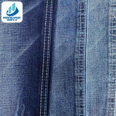 China Wrinkle Resistant Dark Blue Stretch 11.2oz Thick Denim Fabric For Lady Jeans for sale