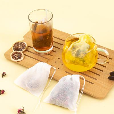 China Eco-Friendly Flower Tea Packaging Non Woven Filter Pouch Disposable Tea Infuser Natural Empty Tea Bag With Strings for sale