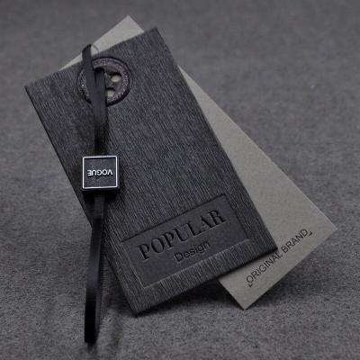 China Customized Viable Printed Logo Foil Hang Tag Black Cardboard Paper UV Swing Tags Jeans Clothing Hang Tags for sale