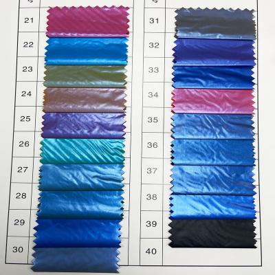 China 100% Polyester Nylon Waterproof Fabric Many Color Windproof Raincoats For Winter Down Jacket for sale