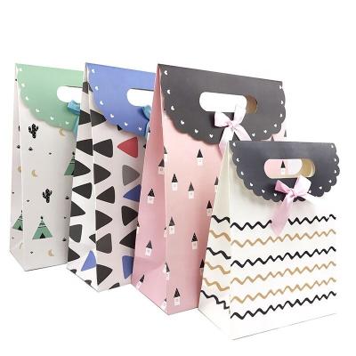 China Bowknot Birthday Gift Bag Recyclable Exquisite Paper Bags Gift Wrapping Bag Wholesale Christmas Stocking Children's Random Gift Bag for sale