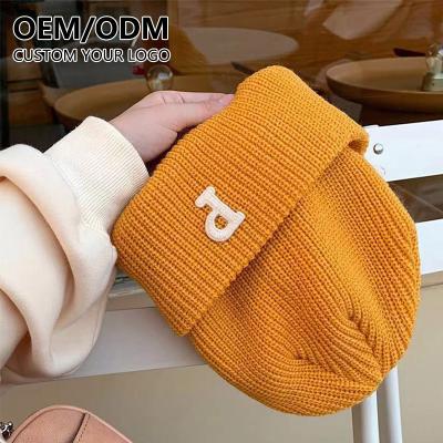 China JOINT Designer Unisex Trendy Woven Custom Label Knitted Warm Winter Beanie Hats With Working Logo for sale