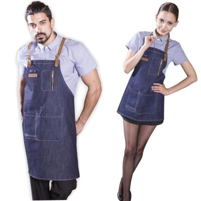 China Trendy Make Fashion Jean Leather Shoulder Straps Long Denim Apron With Zipper Pockets For Kitchen Nail Salon Bar Cafe for sale