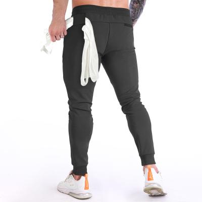 China Breathable Customize Men's Running Fitness Zipper Pockets Joggers Pants Shaping Tapered Workout Sweatpants With Towel Loop Hanging for sale