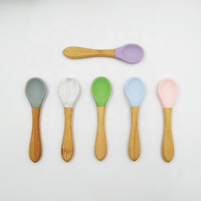 China BPA Free Custom Color Baby Spoon Food Grade Silicone Baby Feeder Bamboo Spoon With Wooden Handle for sale