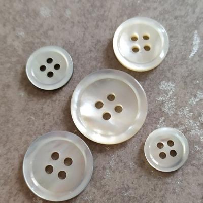 China Wholesale Eco - Friendly 4 Holes Washable Round Black MOP Shell Buttons Custom Made for sale