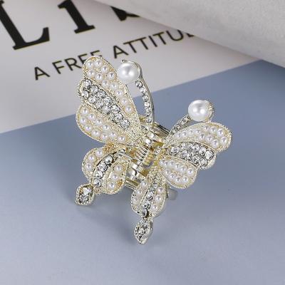 China ALLOY pearl butterfly ponytail hairpin temperament pearl girl hairpin big claw Korean hollow hair bow for sale