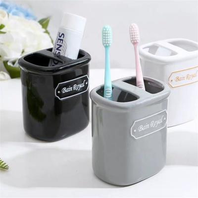 China Sustainable Luxury Hotel Bathroom Toothbrush Cups Compartment Design Ceramic Toothbrush Holder for sale