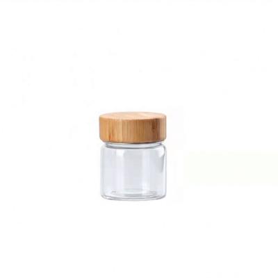 China Small Capacity Freshness Preservation 50Ml Borosilicate Glass Containers Tops With Bamboo Screw Lids Spice Storage Jars 2Oz for sale