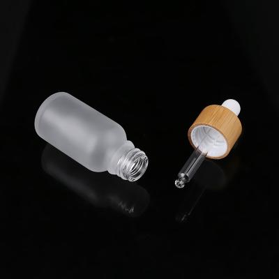 China Small 20ml cosmetic blue glass chemical bottle with bamboo deropper for e cap oil for sale