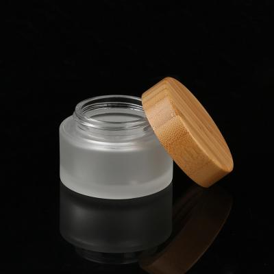 China 15g 20g eco-friendly recyclable clear eye cream lip balm frosted glass cosmetic jar with bamboo lid for sale