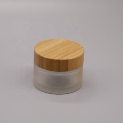 China Custom Color Cosmetic Cream Logo 20g 30g 50g 100g Empty Round Clear Glass Jar Eco-friendly Cosmetic Jar With Bamboo Cap for sale