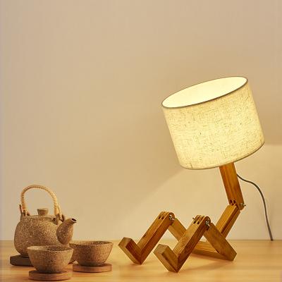 China Creative Nordic Bedroom Bedside Study Style Humanoid Lamp Fashion Robot Folding Modern Solid Wood Wooden Table Lamp for sale