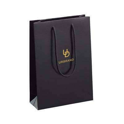 China Recycled Materials Customized Matte Laminated Folding Branded Paper Bags With Ribbon Rope Handle Printing Paper Jewelry Bag With Silver Foil Logo for sale